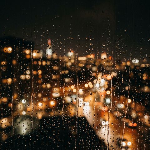 Pluie sur une vitre, lumières floues de la ville